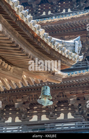 Wooden roof detail of Tokondo and Five-story pagoda (Go-Ju-No-To) in the background at Kofuku-ji temple. Located in Noborioji district, Nara, Japan Stock Photo