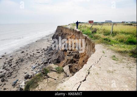 Sea storm tidal coastal erosion at Skipsea, Holderness, Yorkshire east coast England. South along severed coast road Stock Photo