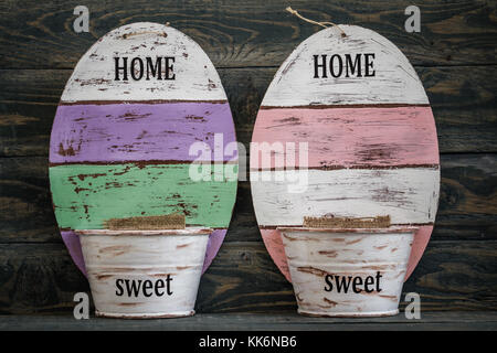 Close view of colorful empty wall pots on dark blue wooden background Stock Photo