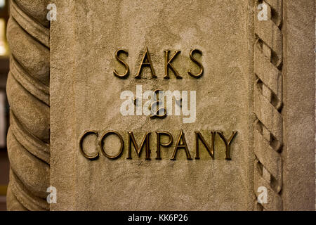 New York, New York - October 29, 2016: Saks and Company signage on the flagship Fifth Avenue store of high end department store Saks Fifth Avenue. The Stock Photo