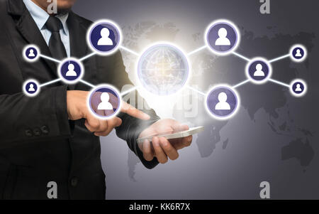 Businessman using the smart phone with the Social media symbol on world map,Elements of this image furnished by NASA, Business network concept Stock Photo
