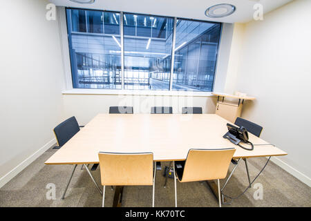 Empty small meeting room. Bright modern interior. Glass walls Stock Photo