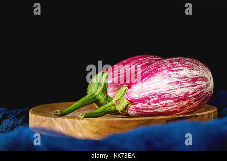 Healthy and tasty purple eggplants on a dark background. Stock Photo