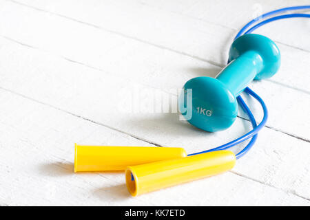 Sport and fitness concept with dumbbell and jumping rope Stock Photo