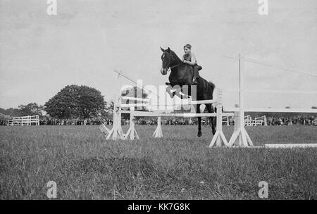 1940s, historical picture, eventing competition, a young lad on a horse jumping a fence, showing good technique and position on the horse,  England, UK. Probably common at this time, is the fact that he is wearing no protective headgear, Stock Photo