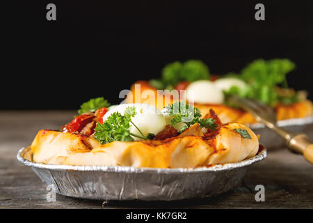 Pie in the oriental style. Filo pastry with tomato and mozzarella. Dark background. Vegetarian food Stock Photo