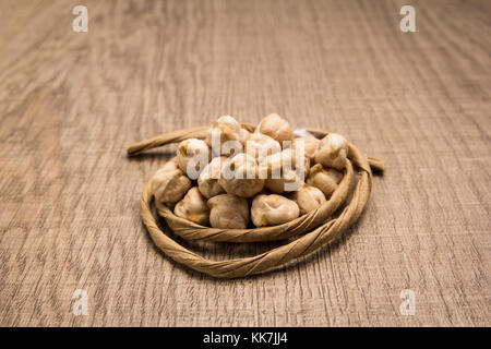 Cicer arietinum is scientific name of Chickpeas legume. Also known as Garbanzo bean, Chick Peas or Grao de Bico. Paper rope around grain. Selective fo Stock Photo