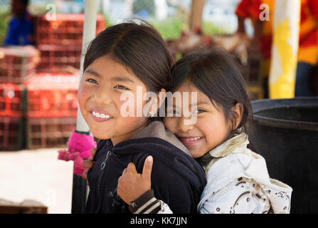 Ecuador children - two young indigenous Ecuadorian girls aged 8-10 years; Otavalo, Ecuador South America Stock Photo