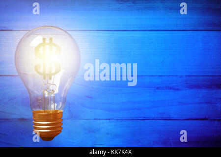 Light bulb with Dollar symbol on blue wooden background. Money making idea concept Stock Photo