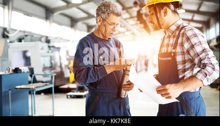 Supplier with engineer checking on production in factory Stock Photo