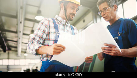 Supplier with engineer checking on production in factory Stock Photo