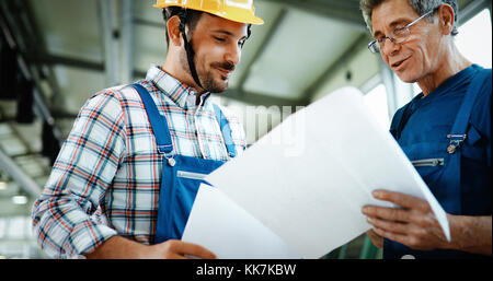 Team Of Engineers Having Discussion In Factory Stock Photo