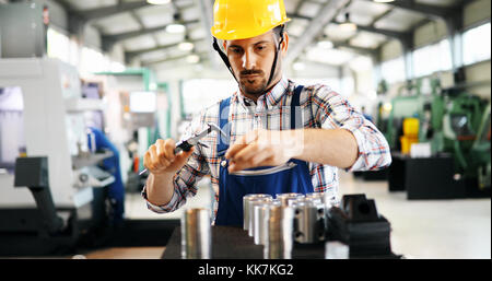 Male worker and quality control inspection in factory Stock Photo