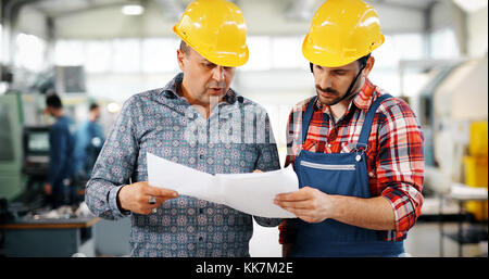 Supplier with engineer checking on production in factory Stock Photo