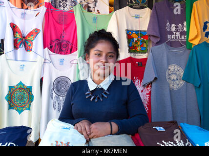 Otavalo market stall and teenage woman stallholder, Otavalo market, Ecuador South America Stock Photo