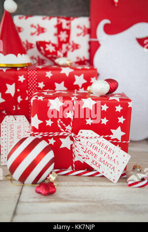 Christmas presents in red and white wrapping paper Stock Photo