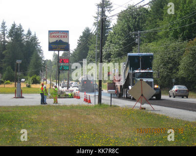 In 2018 WSDOT contractor crews from Granite Construction put a new surface on SR 20 between Sedro-Woolley and Concrete. The new surface is put down over the existing road (once road repair and crack sealing is done) to help protect the road from weather and traffic wear-and-tear. This work is much less expensive than paving and extends the life of the current pavement however, unlike paving, it does not create a new pavement surface for drivers, just coats the surface that is already there. SR 20 resurfacing 36273901144 o Stock Photo