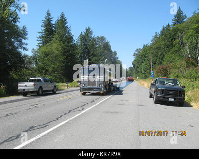 In 2018 WSDOT contractor crews from Granite Construction put a new surface on SR 20 between Sedro-Woolley and Concrete. The new surface is put down over the existing road (once road repair and crack sealing is done) to help protect the road from weather and traffic wear-and-tear. This work is much less expensive than paving and extends the life of the current pavement however, unlike paving, it does not create a new pavement surface for drivers, just coats the surface that is already there. SR 20 resurfacing 36273899934 o Stock Photo