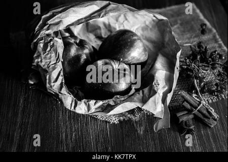 conceptual picture apples wrapped in a paper bag. illuminated by the setting sun. Stock Photo