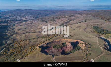 volcanic crater in Racos village. Brasov county, Transylvania, Romania. Aerial view Stock Photo