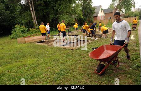 Sailors assigned to the guided-missile destroyer USS Donald Cook DDG 75 and the amphibious transport dock ship USS San Antonio LPD construct a community garden in Baltimore, Maryland, 2012. Image courtesy Mass Communication Specialist 2nd Class Josue L. Escobosa/US Navy. Stock Photo