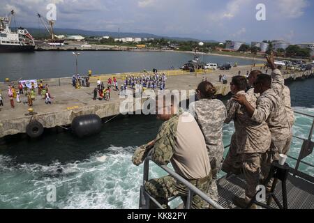 Service members with Pacific Partnership 2015 wave to locals from aboard the Military Sealift Command joint high speed vessel USNS Millinocket JHSV 3, San Fernando City, Philippines. Image courtesy U.S. Marine Corps photo by combat correspondent Sgt. James Gulliver/US Navy, 2015. Stock Photo