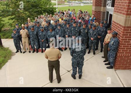Rear Admiral Eric Coy Young, commander of Navy Reserve Forces Command, and Lt Col Alvin Bryant, an inspector and instructor with the 3rd Battalion, 14th Marines, address Sailors, Airmen, and Marines before a moment of silence to honor the five service members killed July 16 in an active shooter attack at the Navy Operational Support Center in Chattanooga, Tennessee, photo taken in Hattanooga, Tennessee. Image courtesy Logistics Specialist 1st Class America Henry/US Navy, 2015. Stock Photo