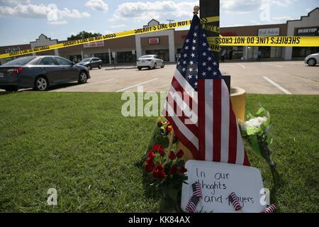 Police tape and a makeshift memorial frame the scene at an Armed Forces Career Center, where earlier in the day an active shooter opened fire, injuring one US Marine, Chatanooga, Tennessee. Image courtesy Damon J. Moritz/US Navy, United States, 2015. Stock Photo