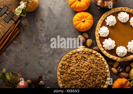 Fall traditional pies pumpkin, pecan and apple crumble Stock Photo
