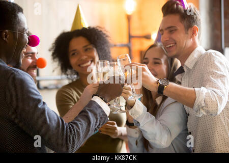 Happy black and white friends clinking glasses celebrating party Stock Photo