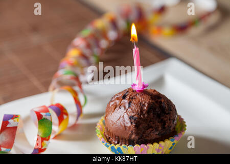 cupcake with a birthday candle on plate Stock Photo