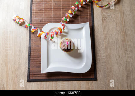 cupcake with a birthday candle on plate Stock Photo