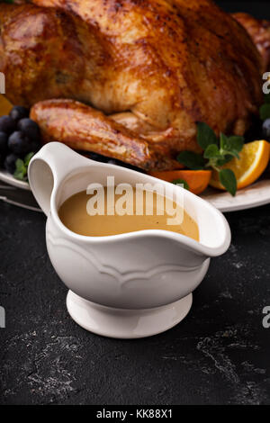 Homemade gravy in a sauce dish with turkey Stock Photo