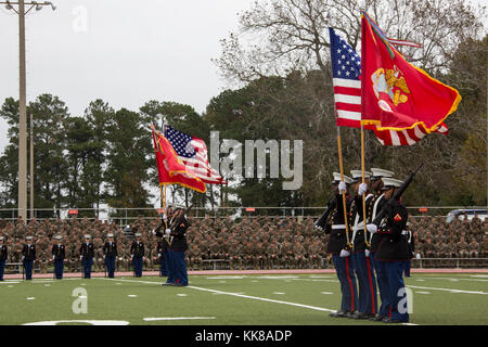 U.S. Marines with color guards from various units display the colors during the Joint Daytime Ceremony, Harry B. Liversedge field, Camp Lejeune, N.C., Nov. 8, 2017. The annual ceremony was held in honor of the 242nd Marine Corps birthday. It included a historical uniform pageant, rededication of national and U.S. Marine Corps Colors and the traditional birthday cake cutting. (U.S. Marine Corps photo by Sgt. Judith L. Harter) Stock Photo