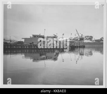 A photograph showing the damage that occurred to the dock in Seward due to the effects of the 1964 Alaska Earthquake, the buildings along the dock can be seen in various states of collapse, large sections of the town were destroyed when multiple tsunamis spread burning oil throughout it, the 92 magnitude earthquake originated in Prince William Sound and is the second largest earthquake ever recorded, Seward, Alaska, 1964. Stock Photo