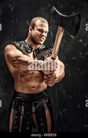 Severe barbarian in leather costume with hammer Stock Photo