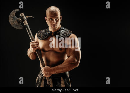 Severe barbarian in leather costume with hammer Stock Photo