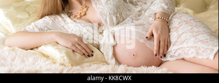 Pregnant woman lying Stock Photo