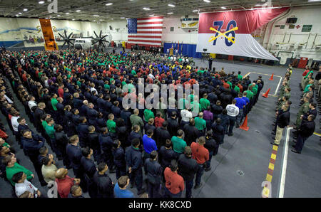 171126-N-OY799-016  PHILIPPINE SEA (Nov. 26, 2017) Sailors gather for a memorial service in honor of Aviation Boatswain’s Mate (Equipment) Airman Matthew Chialastri, Lt. Steven Combs and Aviation Ordnanceman Airman Apprentice Bryan Grosso in the hangar bay of the aircraft carrier USS Ronald Reagan (CVN 76). Chialastri, Combs and Grosso were aboard a C-2A Greyhound from Fleet Logistics Support Squadron (VRC) 30 when it crashed Nov. 22 during a routine transport flight carrying passengers and cargo from Marine Corps Air Station Iwakuni to USS Ronald Reagan. (U.S. Navy photo by Mass Communication Stock Photo