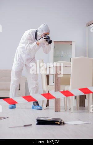 Forensic expert at crime scene doing investigation Stock Photo