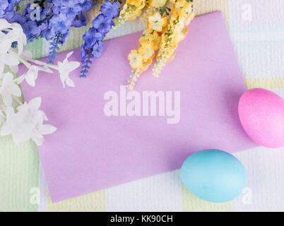 Blank purple envelope with Easter eggs and flowers Stock Photo