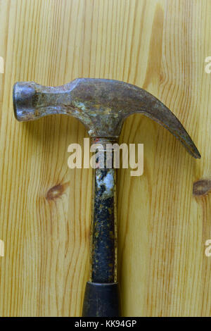 Hammer on wooden background. Vertical top view image with space for text. Stock Photo