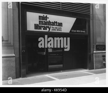 Black and white photograph of the exterior of the entrance to the Mid-Manhattan Library, part of the New York Public Library, New York City, New York, 1972. From the New York Public Library. Stock Photo