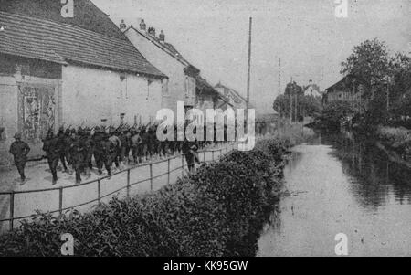 Black and white photograph of a large group of African-American soldiers marching along the side of a river, France, 1919. From the New York Public Library. Stock Photo