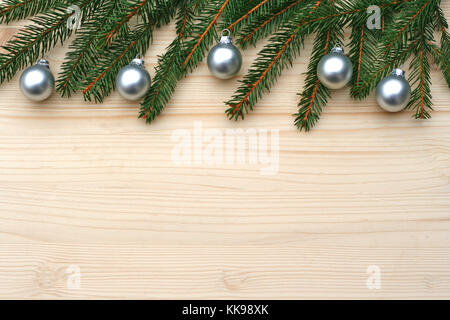vintage Christmas background with fir branches and silver balls on wood Stock Photo