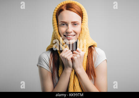 redhead girl wearing knit sweater on head as headscarf Stock Photo