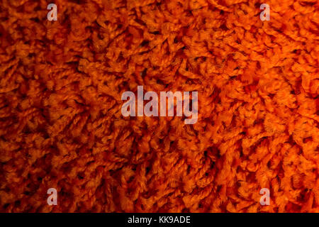 Close up of bright red domestic woolen carpet texture Stock Photo