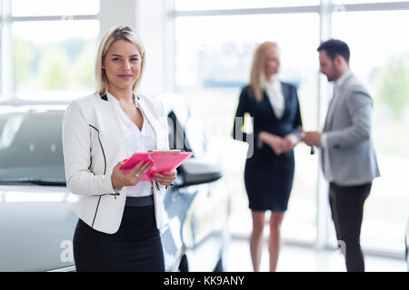 Picture of professional salesperson working in car dealership Stock Photo