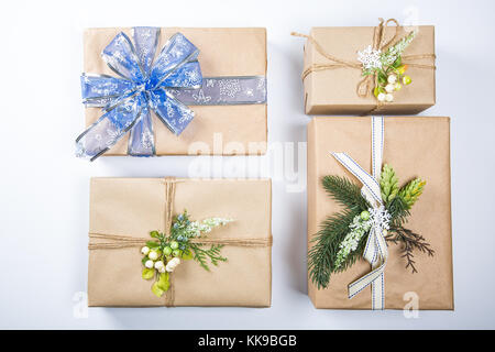 Classy Christmas gifts box presents in brown paper, New Year decor on white. Merry christmas card background Stock Photo