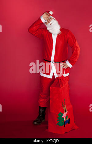 Santa Claus tired of delivering gifts Stock Photo